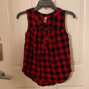 A red and black tank top with cross string over chest